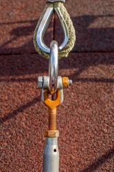 Thimble shackle turnbuckle connection, metal ring and rope, corroded threads, close-up view