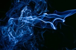 abstract patterns and shapes formed by smoke, blue streaks of smoke against a black background