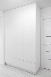 White wardrobe in home interior. Furniture mockup