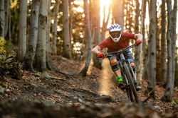 Mountainbiker rides in autumn forest