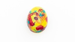 Easter composition with a colored chicken egg on a white background. Concept of Easter parties.