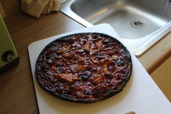 Burnt pizza on a chopping board