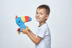 attractive boy with colorful toy parrot