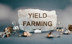 Torn paper with the word Yield Farming, concept of Cryptocurrencies and e-commerce.