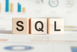 The word SQL structured query language, lined with wooden blocks. Wooden block with words SQL - Structured Query Language.