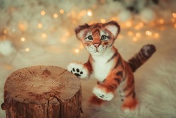 The Year of the tiger. Symbol of the year. A tiger figurine made with your own hands. Children's toy tiger. Tiger in winter. The year is 2022.