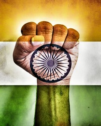 Clenched fist painted with tricolour National flag of India on a Vintage background. Concept of patriotism.Tribute for brave heroes in the fight for freedom.74th Independance day celebration.