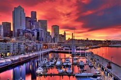High dynamic image of Seattle skyline in dramatic sunrise colors across pier-66 waterfront