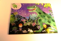 Complete puzzle. Green dinosaur at night. Many small details. Children's puzzle entirely finished.