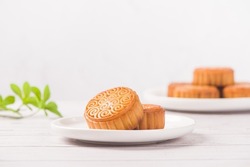 Traditional Chinese mid autumn festival mooncake on white wooden table