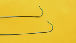 Angioplasty guiding catheter(AL-2 catheter) used to treat blockages of the arteries of heart . Image isolated on a yellow background 