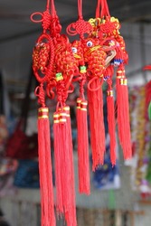 Fabric handcrafted red dragons - symbol, dreamcatcher or decorative object at a farmers market stall in Hilo, Big island, Hawaii