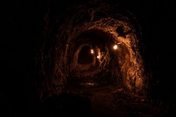 Historic gold mining shaft in Walhalla, Melbourne, Australia. This tunnel is what remains of the gold rush era in Australia with the eerie lighting to showcase the dark depths. 