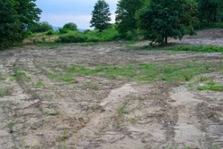 building plot, prepared for building a house. Leveled land on the plot before starting the construction of the house. Earthworks preparatory to building a house. Building plot in the countryside.