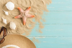 Sand and shells on the wooden floor of the blue,summer concept