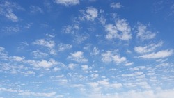 Puffy white clouds and blue sky suitable for background or sky subsitution