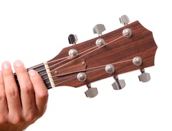 Headstock of the guitar with hands touching