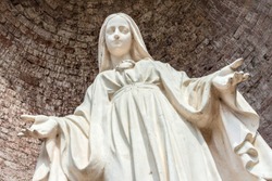 Close-up of Our Lady with open arms, bottom view.