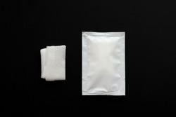 Blank white sachet packets stack mockup isolated on black background. Empty airtight pack mock-up for wet wipe.