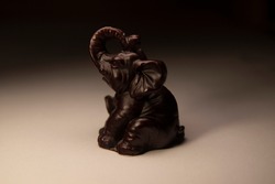 Wooden figurine of an elephant. Wooden elephant. Macro photo of an elephant figurine. Elephant.