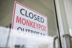 Monkeypox outbreak concept. text message paper Attached behind glass to closed service during the monkeypox virus outbreak.