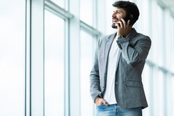 Young business man talk phone in office
