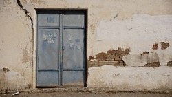 metal door in degraded wall as background