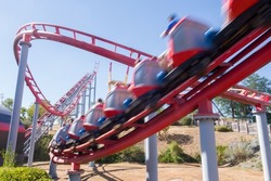 a high-speed ride. A carnival. a roller coaster. A thrilling ride. An amusement park