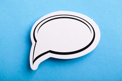 Blank white speech bubble isolated on blue background.
