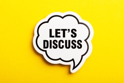 Let s Us Discuss speech bubble isolated on the yellow background.