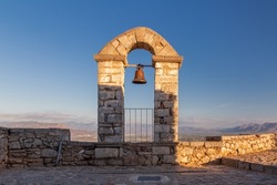 Bell tower in Palamidi fortress on a hill above vast valley surrounded by mountains, Nafplio, Greece