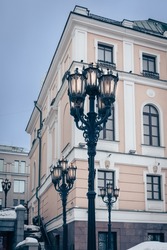 Vintage cast iron lamp posts in front of a classical building, Moscow, Russia