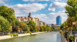 Cityscape view across Dambovita river city of Bucharest in autumn season in Romania
