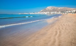 Agadir beach on the Atlantic African coast in the summertime with yellow sand and turquoise water in Morocco