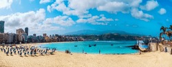 Panorama of the famous Las Canteras beach in the summertime, with tourists enjoying the summer holiday in Gran Canaria