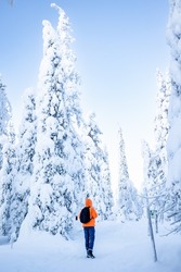 A young man walk in a winter wonderland