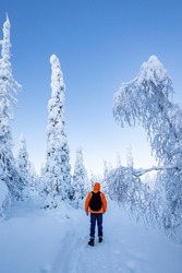 A young man walk in a winter wonderland