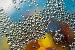 Blue-yellow background. Abstract macrophotography. Oil bubbles. Water texture.