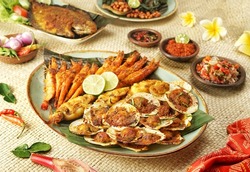 Jimbaran Grilled Seafood or A Balinese dish in the form of charcoal grilled fish, served with Plecing Kangkung and three kinds of chili sauce, Sambal Matah, Sambal Kecap and Sambal Terasi. 