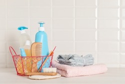 Set of baby toiletries, child organic hygiene and bath accessories, shower gel, shampoo, essential oil, towel in the bathroom
