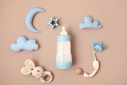 Flat lay with baby sleep accessories with milk bottles, pacifier and toys. Newborn sleeping rules concept