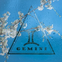 zodiac sign Gemini in a triangle, the element of air in the horoscope, the sign Gemini against the blue sky.