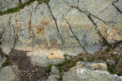 Scoured granite bedrock, with glacial striations and a large groove, on the bald summit of Mt. Kearsarge in Wilmot, New Hampshire.