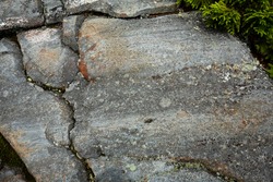 Glacially carved granite bedrock with striations, in a hiking trail near the summit of Mt. Kearsarge in Wilmot, New Hampshire.