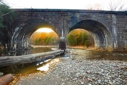 Stone arch Railroad bridge over the West Branch of the Westfield River, along the Keystone Arch Bridges Trail near Chester, Massachusetts, in late autumn.