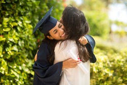 Proud mother hugging her daugher at her graduation