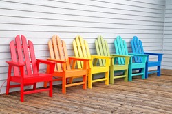 Colorful  wooden chairs on wooden floor 