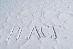 The word peace is written in the snow. Letters calling for the unification of countries around the world. The concept of peaceful coexistence of the population. Text to write in the snow