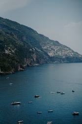 Panoramic views of Positano in the Amalfi Coast in Italy. The view of Positano town, buildings, roads, boats and the sea.