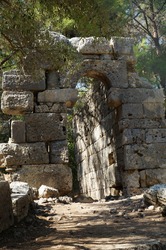 Entrance to the ancient building in the destroyed antique city of Faselis in the south of Turkey
